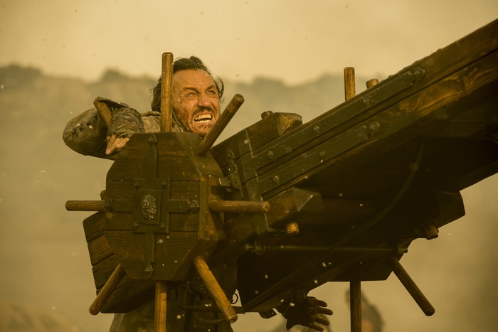 Bronn from Game of Thrones operating a siege weapon