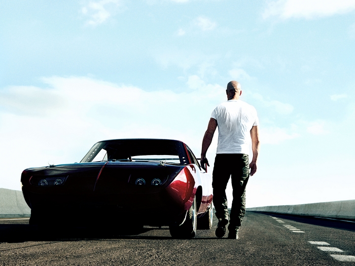 Dominic Toretto from Fast & Furious walking next to a car