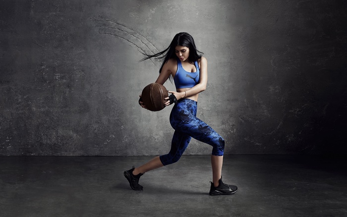 Kylie Jenner holding a basketball for Puma