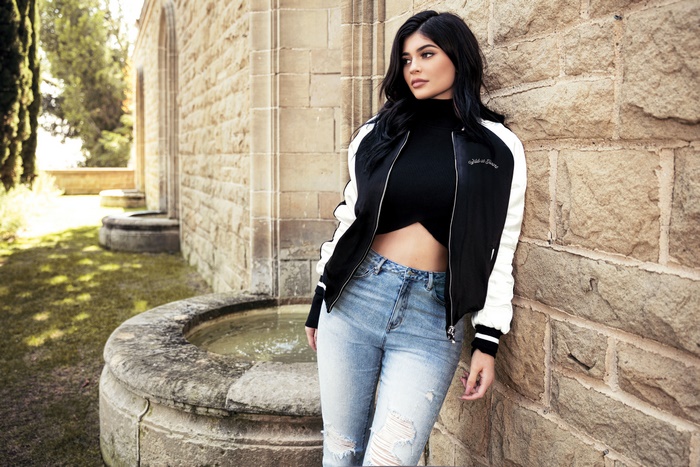 Kylie Jenner Leaning on Stone Wall in Casual Outfit