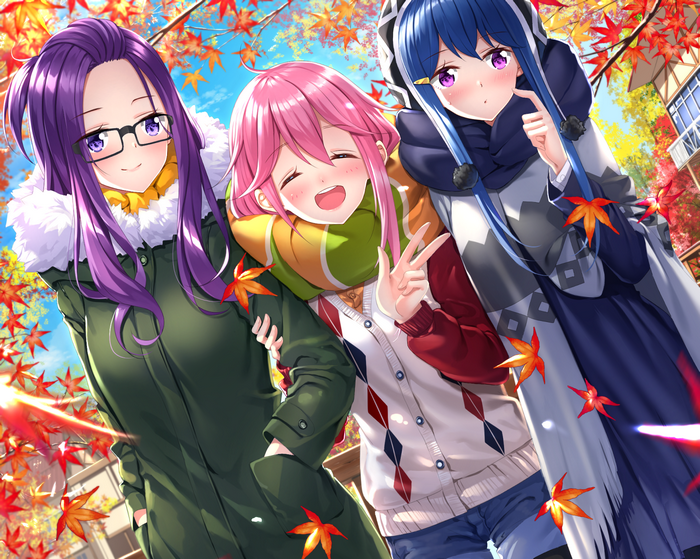 Three girls in autumn with maple leaves