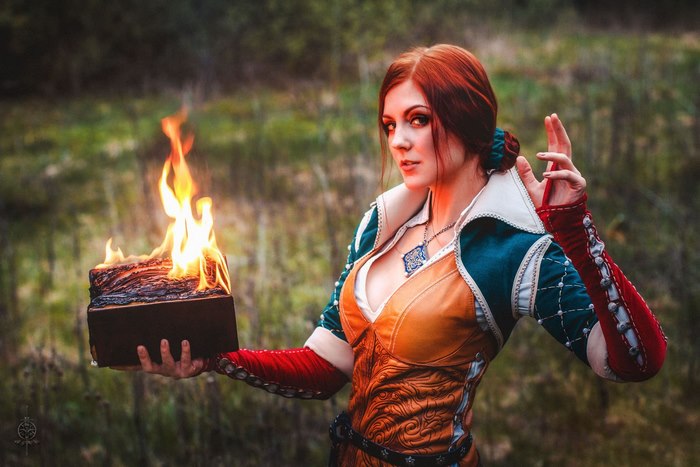 Triss Merigold from The Witcher holding a burning log