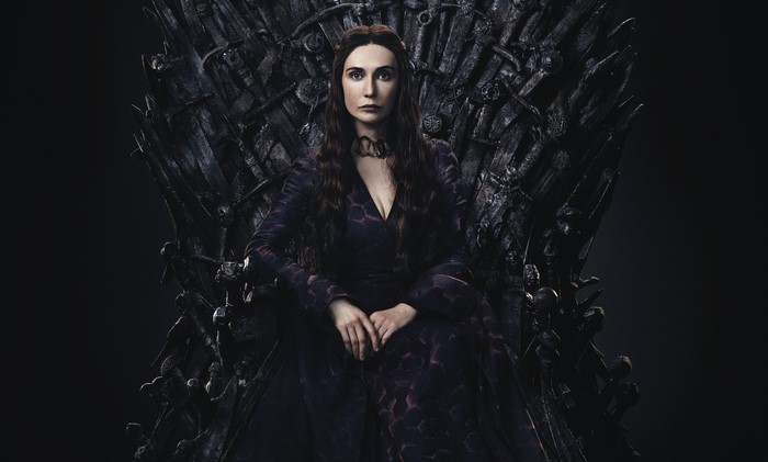 Melisandre from Game of Thrones sitting on the Iron Throne