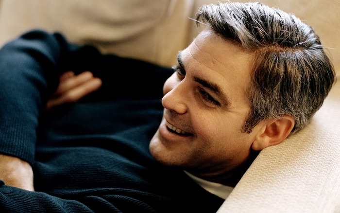 George Clooney lying on a couch