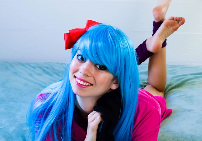 Bulma from Dragon Ball wearing a blue wig and red bow