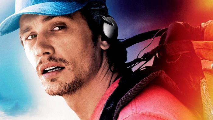 James Franco wearing headphones and a backpack