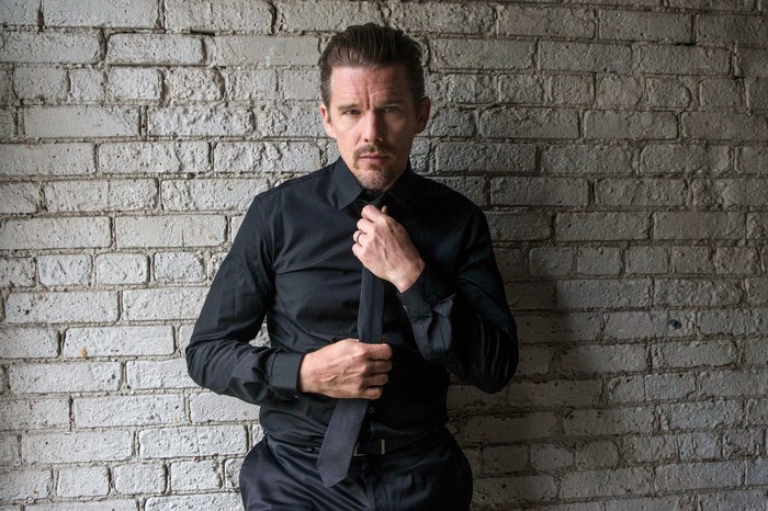 Ethan Hawke adjusting his tie