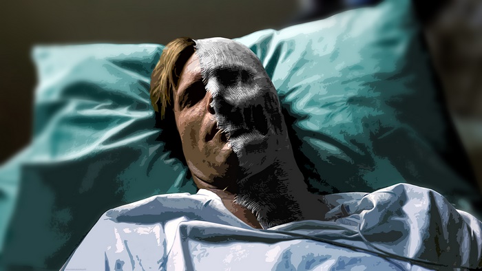 Two-Face lying in a hospital bed