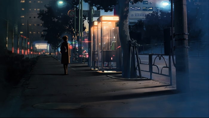 Person walking on a city street at night