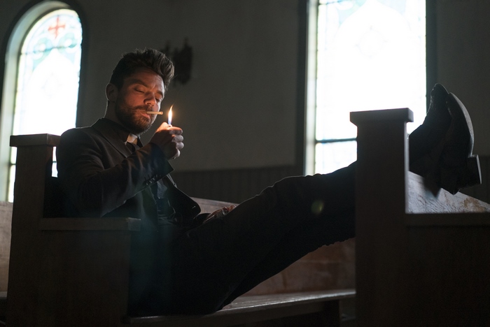 Jesse Custer lighting a cigarette in a church