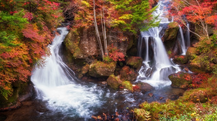 Waterfall in autumn forest with colorful foliage