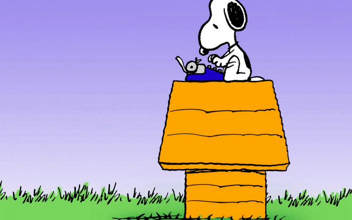 Snoopy typing on his dog house