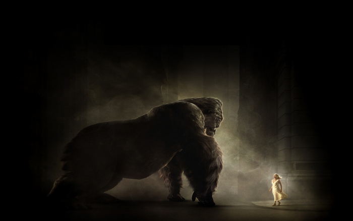 King Kong facing a woman in a dark setting