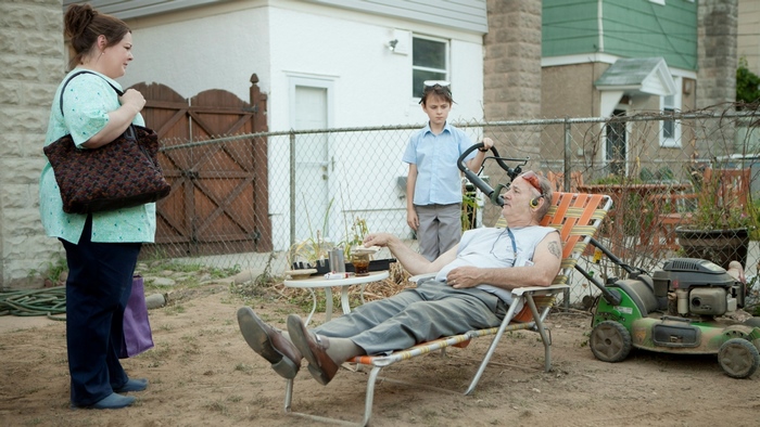 Bill Murray in a backyard with a lawnmower