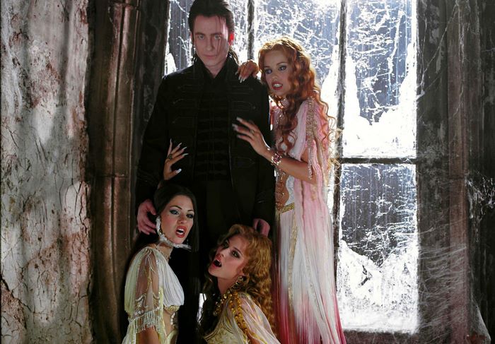 Dracula and three women in a gothic setting