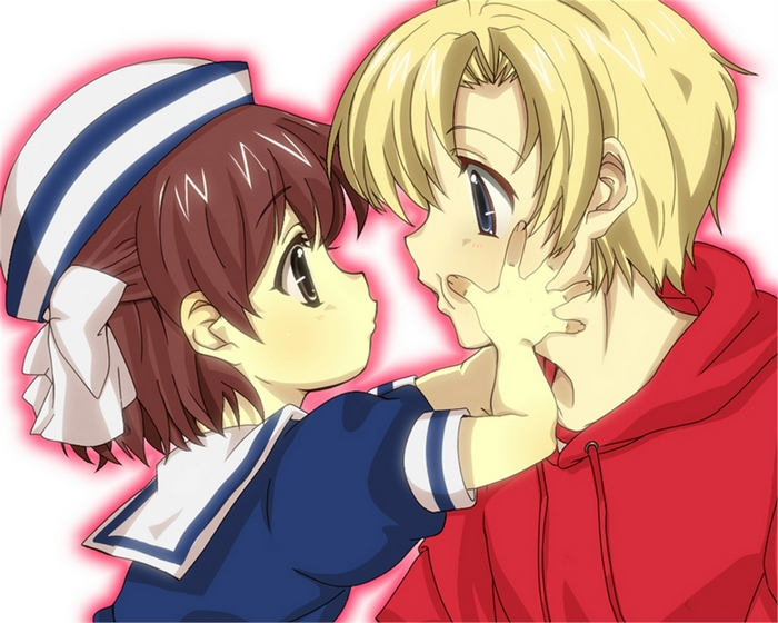 Girl in sailor outfit touching boy's face