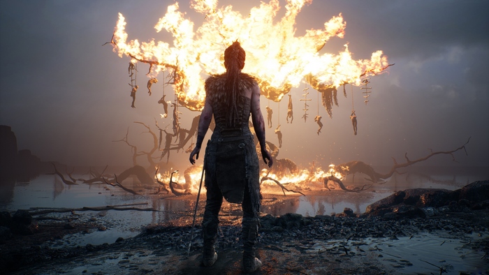 Senua from Hellblade in a burning landscape