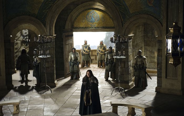 Catelyn Stark and guards in a castle hall