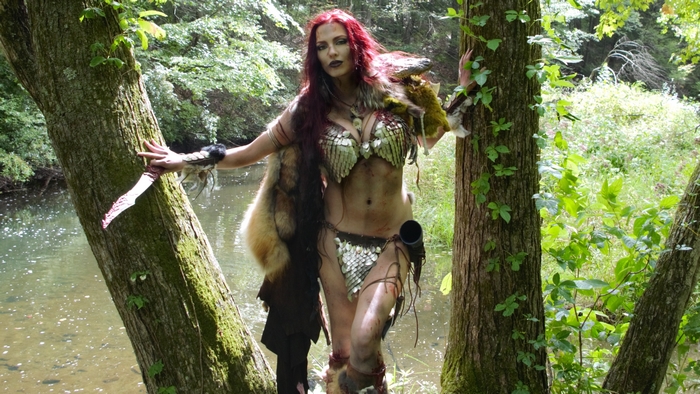 Red Sonja with a knife by a river