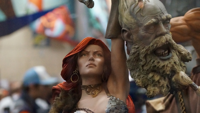 Red Sonja holding a severed head