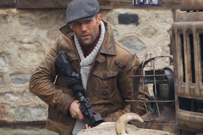 Lee Christmas holding a rifle