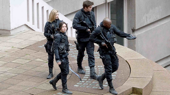 Katniss Everdeen and allies in tactical gear