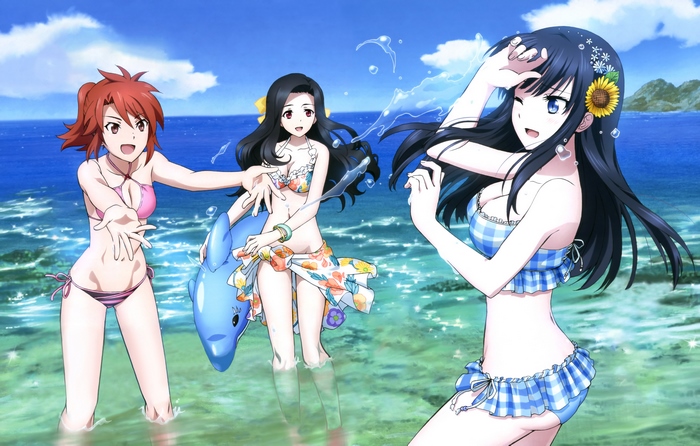 Three girls in swimsuits at the beach