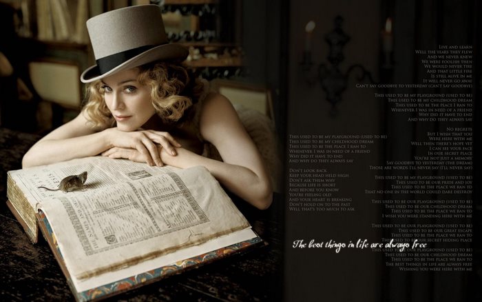 Madonna wearing a top hat with a book and a mouse