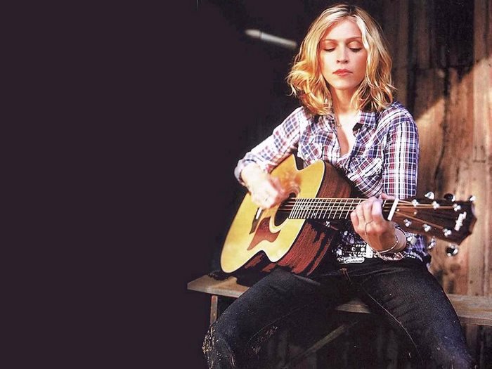 Madonna playing acoustic guitar