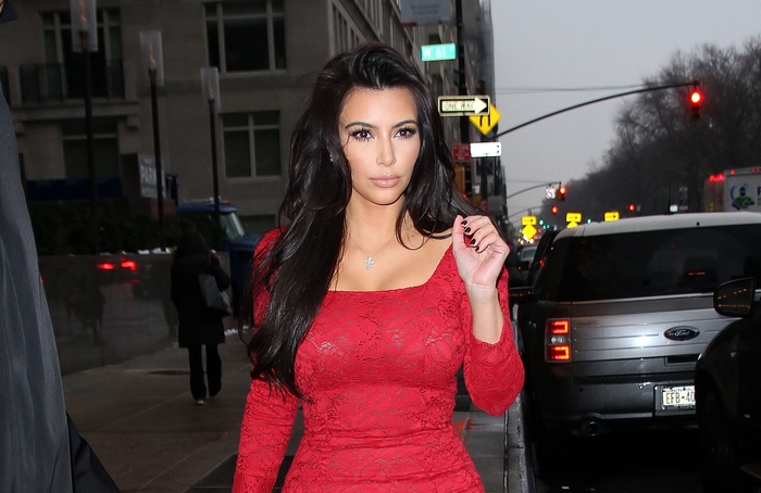 Kim Kardashian in a red dress on a city street