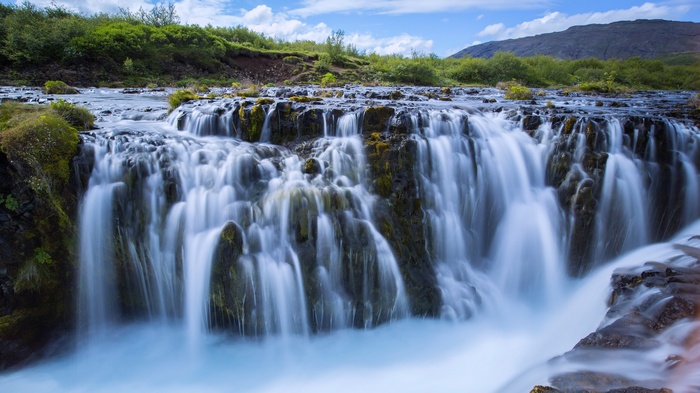 Waterfall cascading over mossy rocks