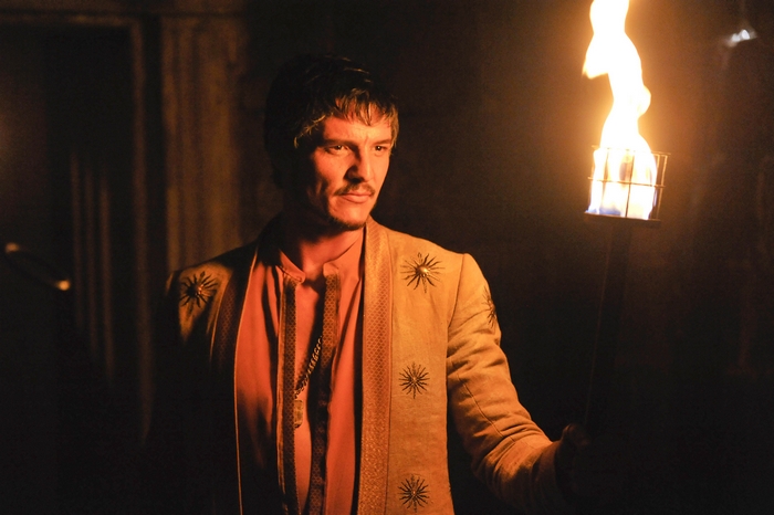 Oberyn Martell from Game of Thrones holding a torch