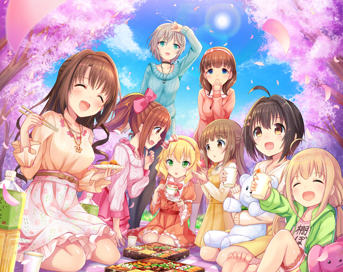 Girls having a picnic under cherry blossoms
