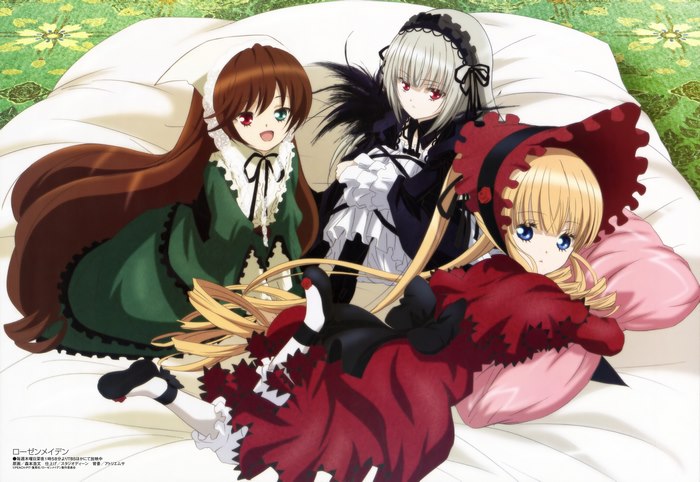Suigintou and other Rozen Maiden dolls on a bed