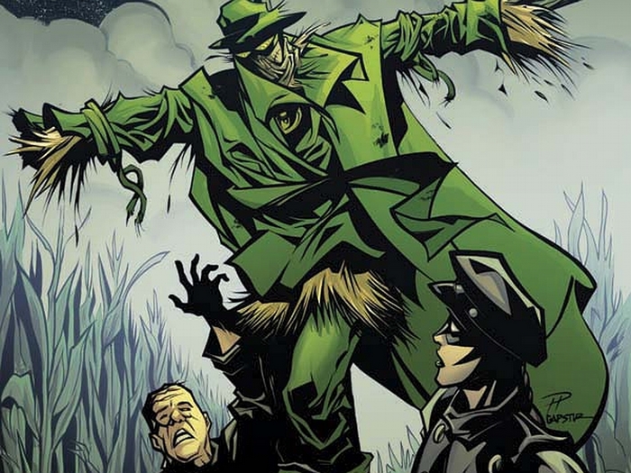 Scarecrow and two people in a cornfield