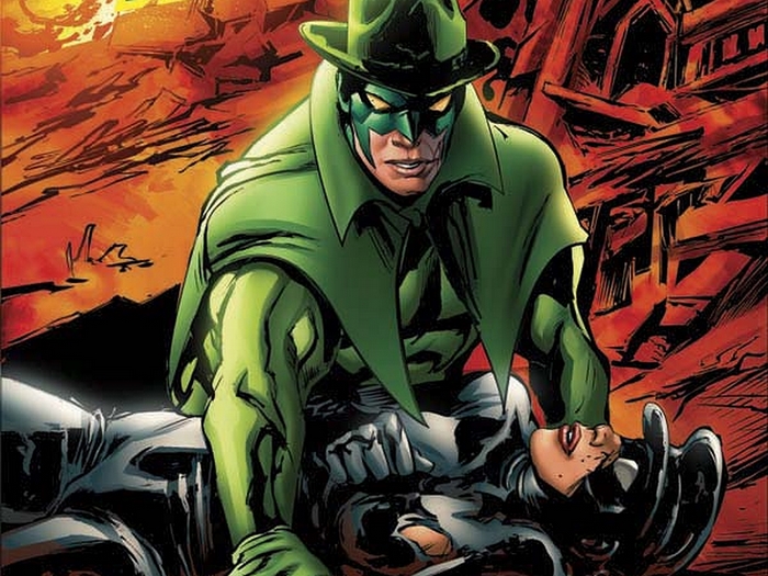 Green Hornet holding an unconscious woman