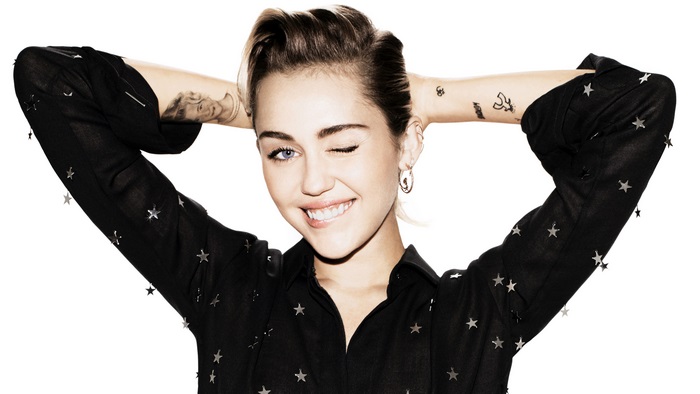 Miley Cyrus with hands behind head