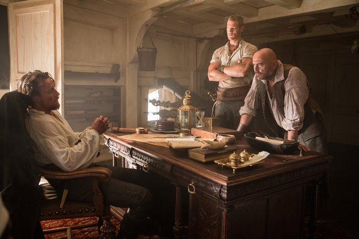 Captain Flint and crew in a ship's cabin
