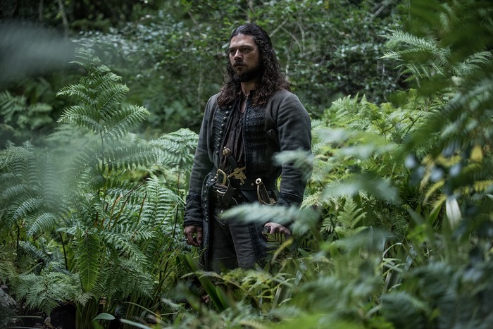 John Silver from Black Sails in a forest