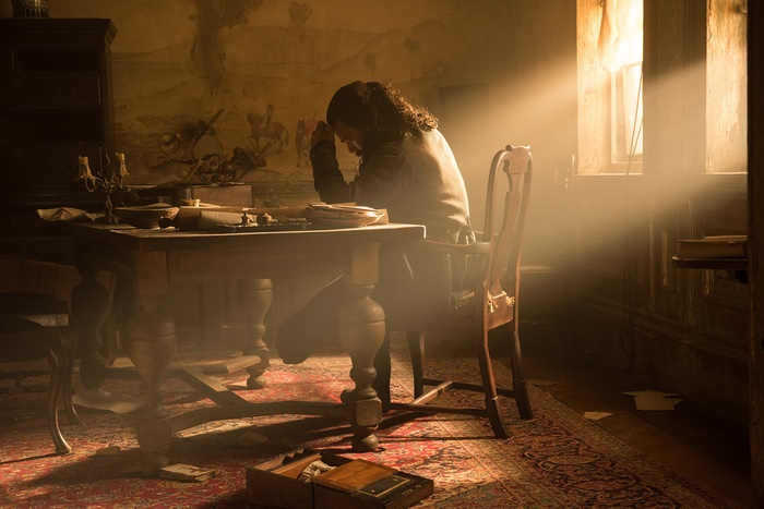 John Silver from Black Sails praying at a desk