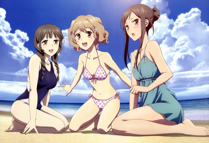 Three girls in swimsuits on a beach