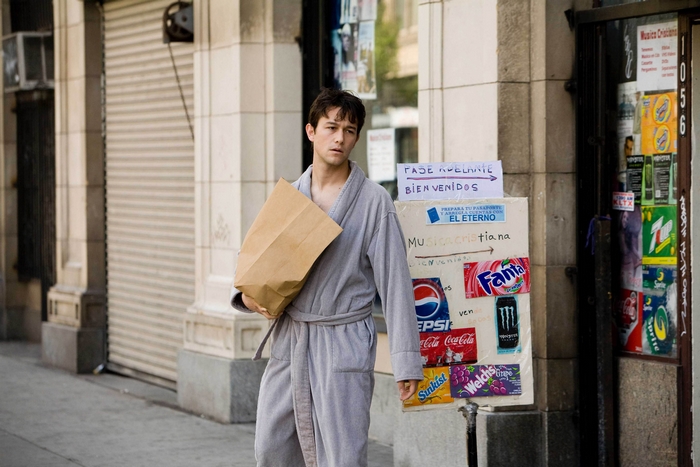 Joseph Gordon-Levitt in a bathrobe holding a paper bag