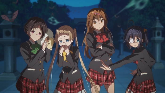 Four girls in school uniforms at night
