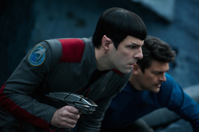Spock from Star Trek holding a phaser