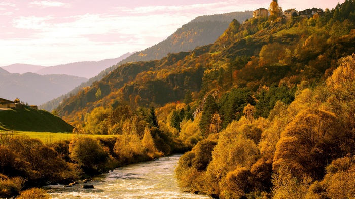 River flowing through a mountain valley in autumn