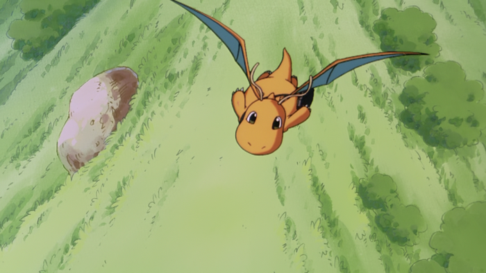 Dragonite flying over a grassy landscape