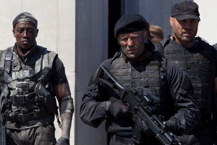 Three men in tactical gear with weapons