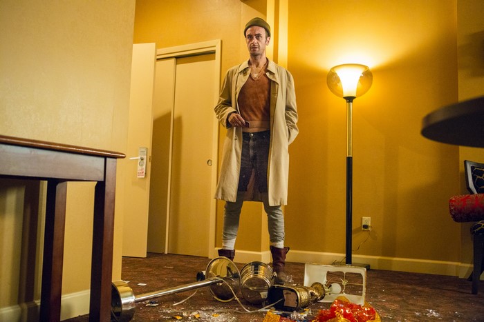 Cassidy from Preacher in a messy hotel room