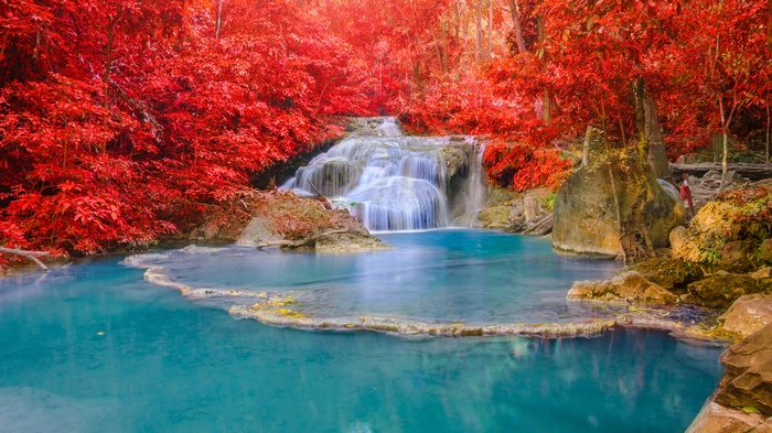 Waterfall with turquoise water and red foliage