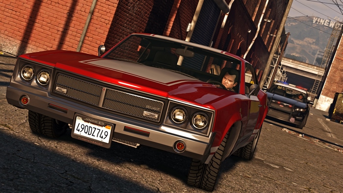 Michael De Santa in a red car pursued by police